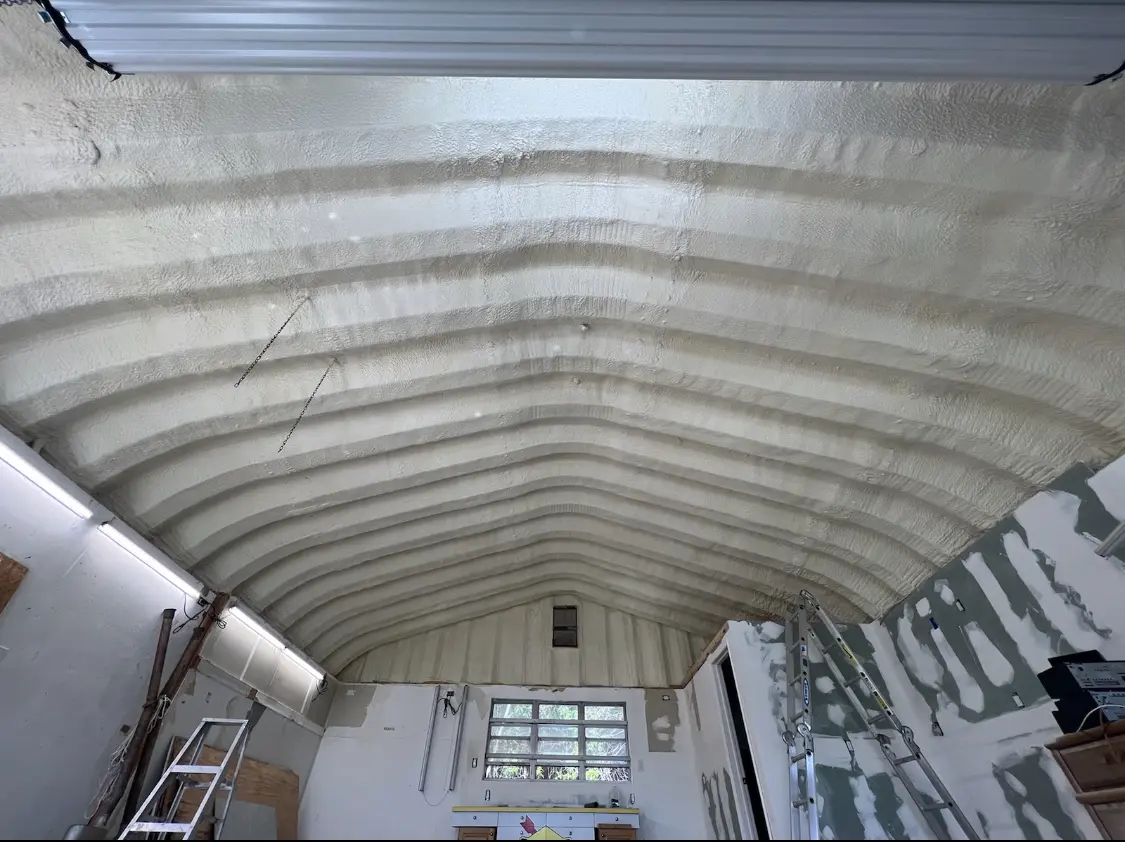 Spray polyurethane foam applied to the underside of a metal roof deck in Kerrville